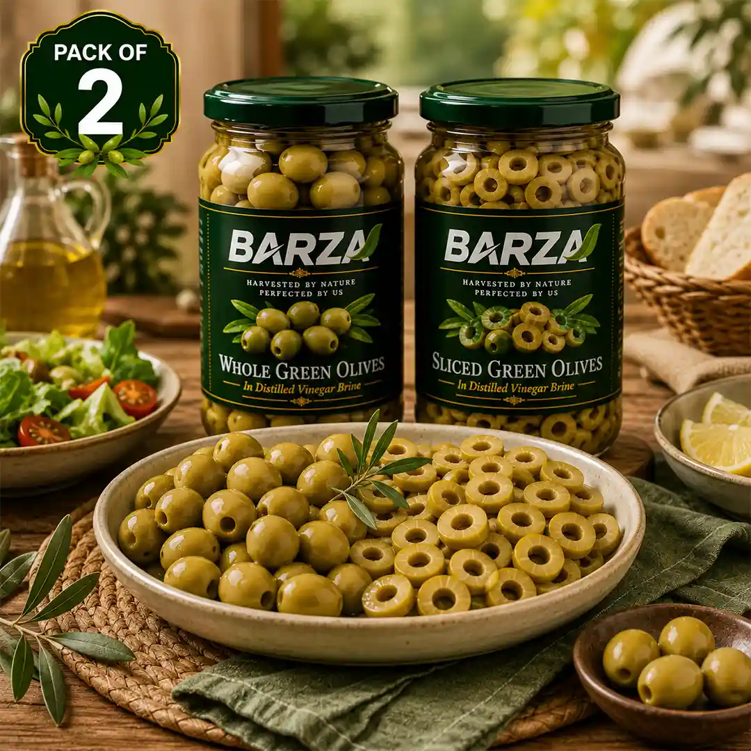 Whole and sliced green olives served together on a serving plate
